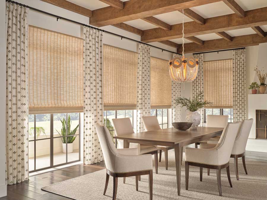 dining room with stamped print drapery fabric and woven wood shades