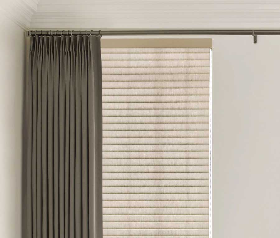 neutral roller shades paired with dark green curtains 