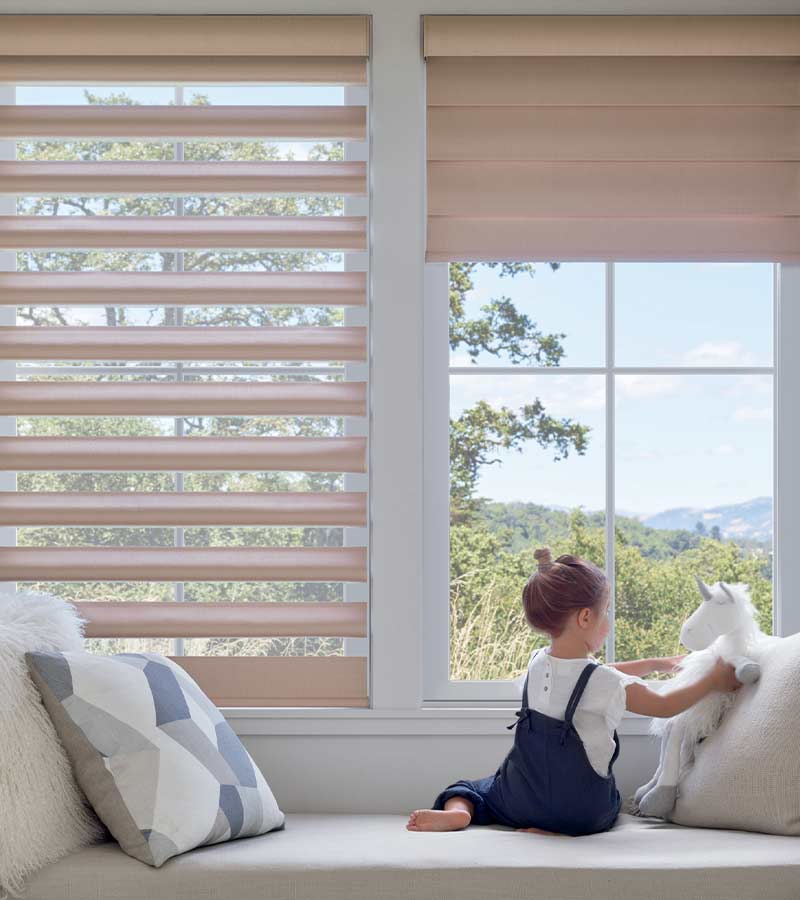 Child safe pirouette shades with child at window seat