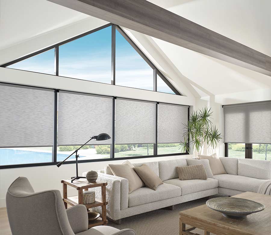 designer roller shades on lower windows in living room