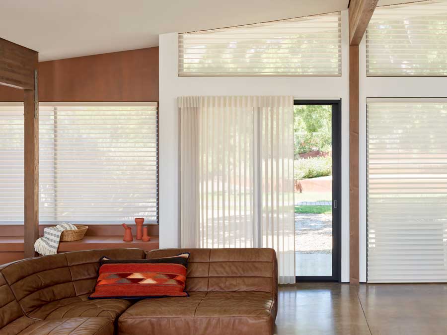 open floor plan with doors and windows with the same fabric in vertical shades and horizontal window shades