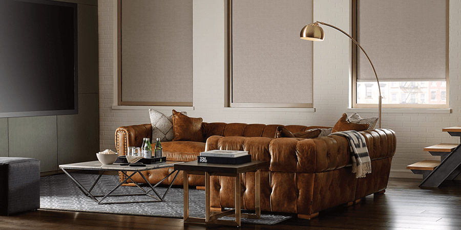 living room with brown leather couch and neutral palette